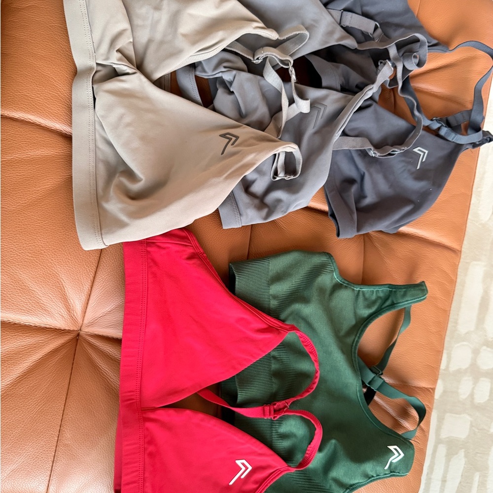 A bundle of Oner Active Sports Bras in Red, Green, Mink, and Grays